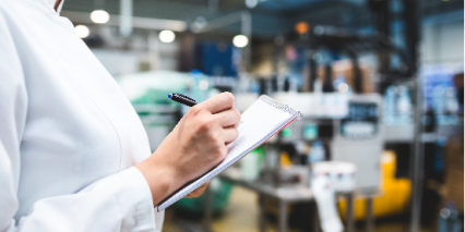 person in lab coat writing