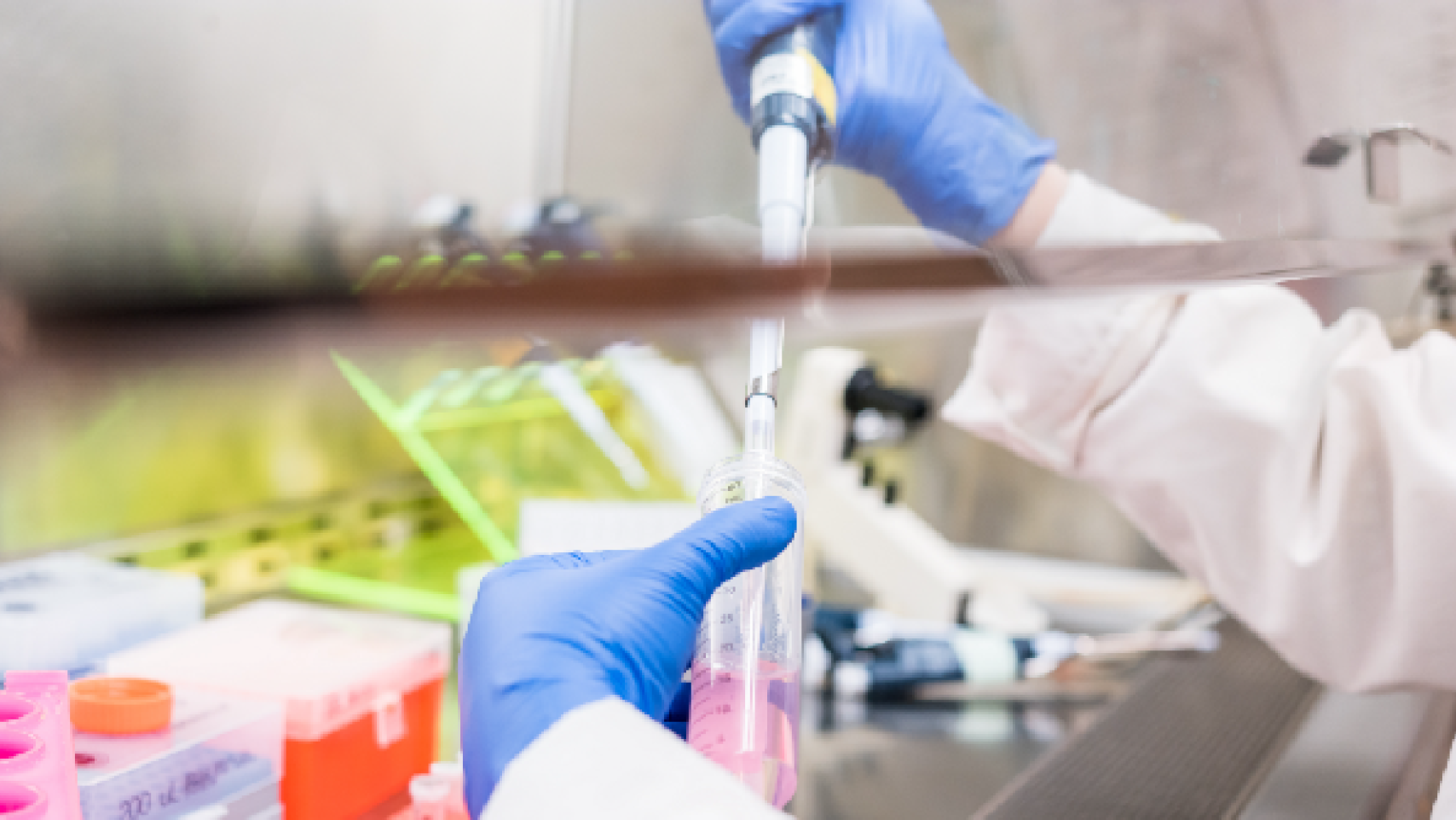 A lab worker is suspending cells in a solution.